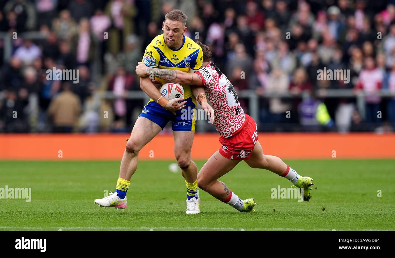 Warrington Wolves' Matt Dufty is tackled by Leigh Leopards' Keanan ...