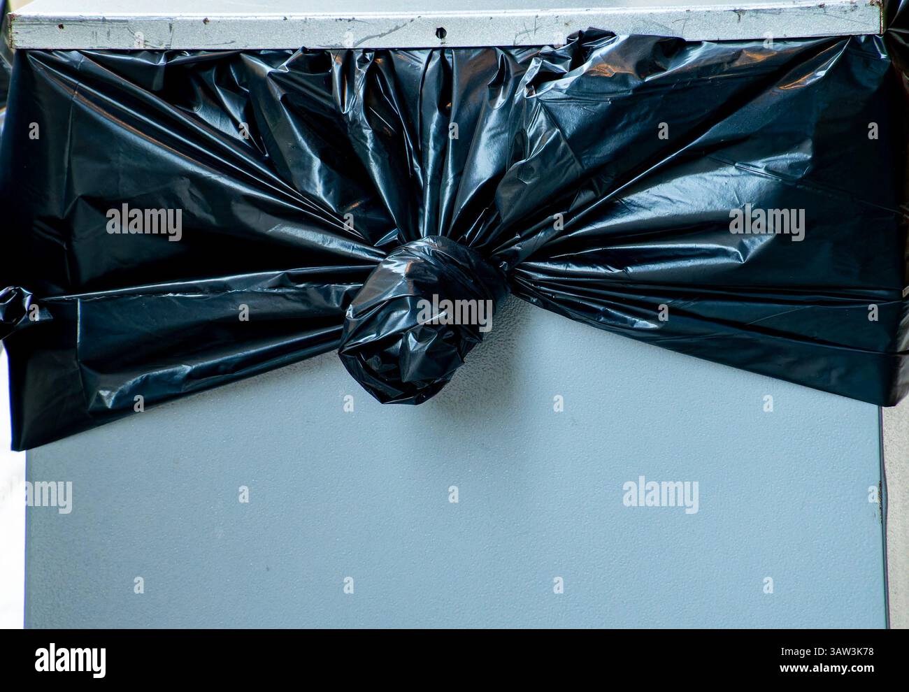 Trash bag tied to the bin Stock Photo