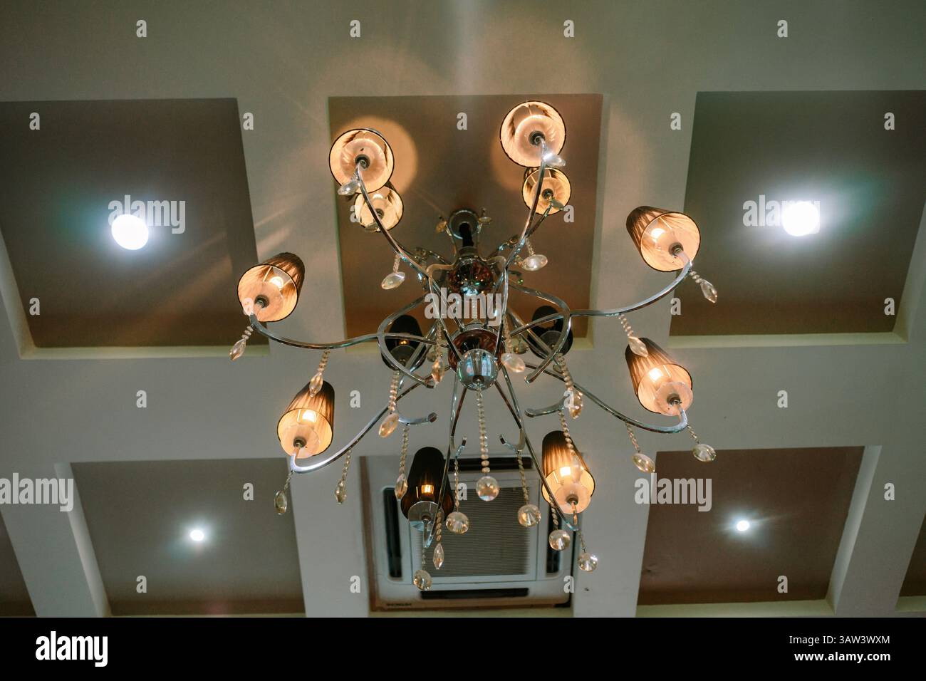 An ornate chandelier hangs from the ceiling, adding a touch of elegance ...