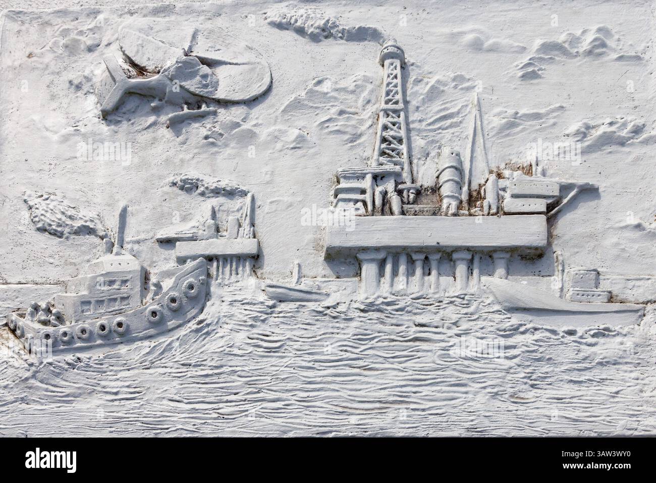 Sculpture panel depicting oil platform drilling, Petroleum museum, Miri, Malaysia Stock Photo