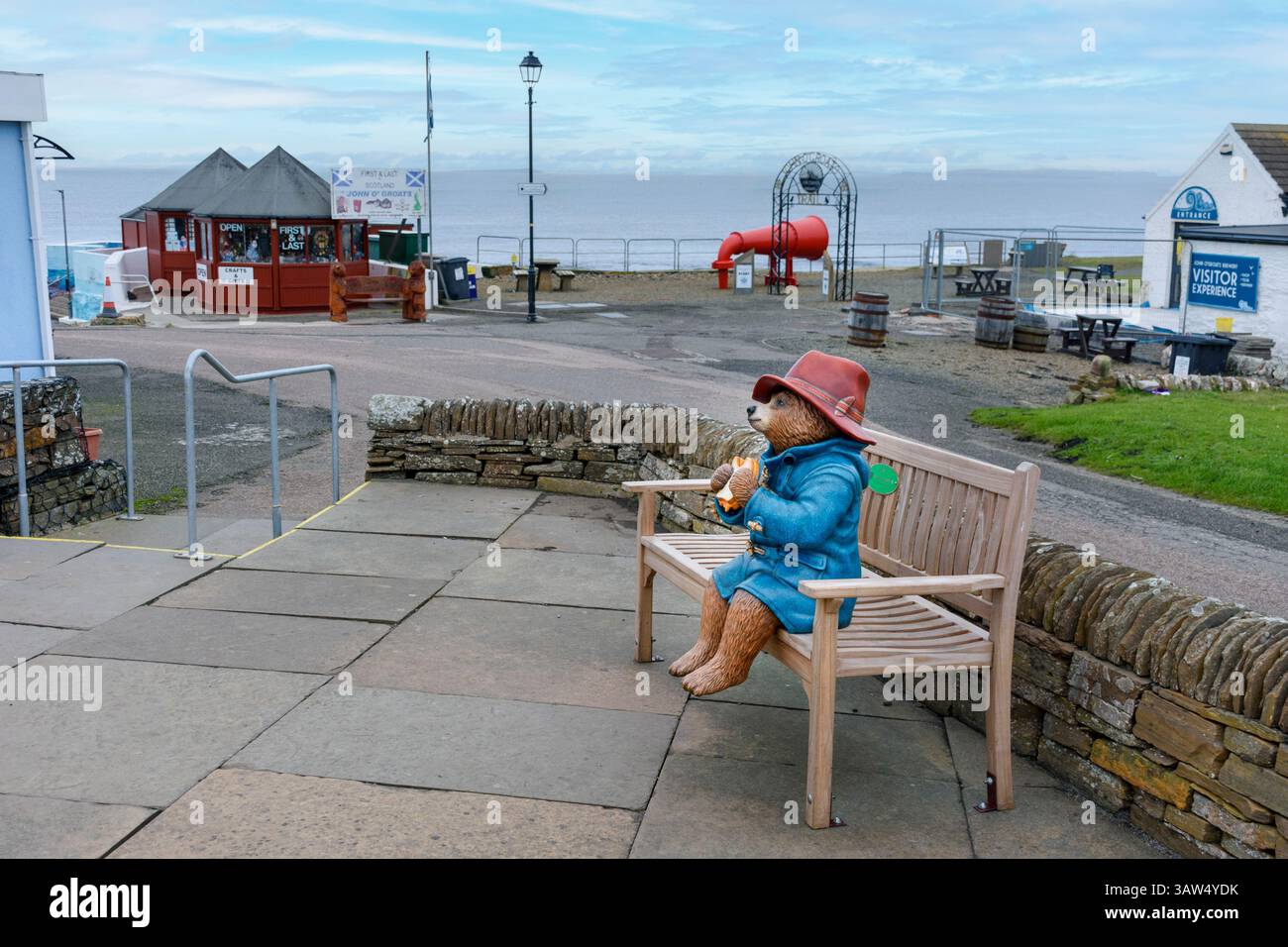 Statue of Paddington Bear sitting on a bench eating a marmalade sandwich.  John o'Groats, Caithness, Scotland, UK Stock Photo