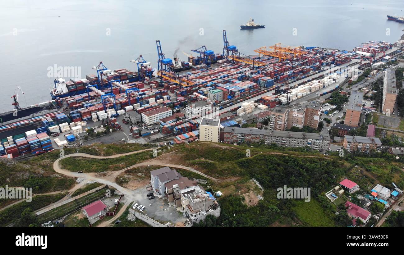 Aerial view of a bustling cargo port, showcasing cranes loading and ...