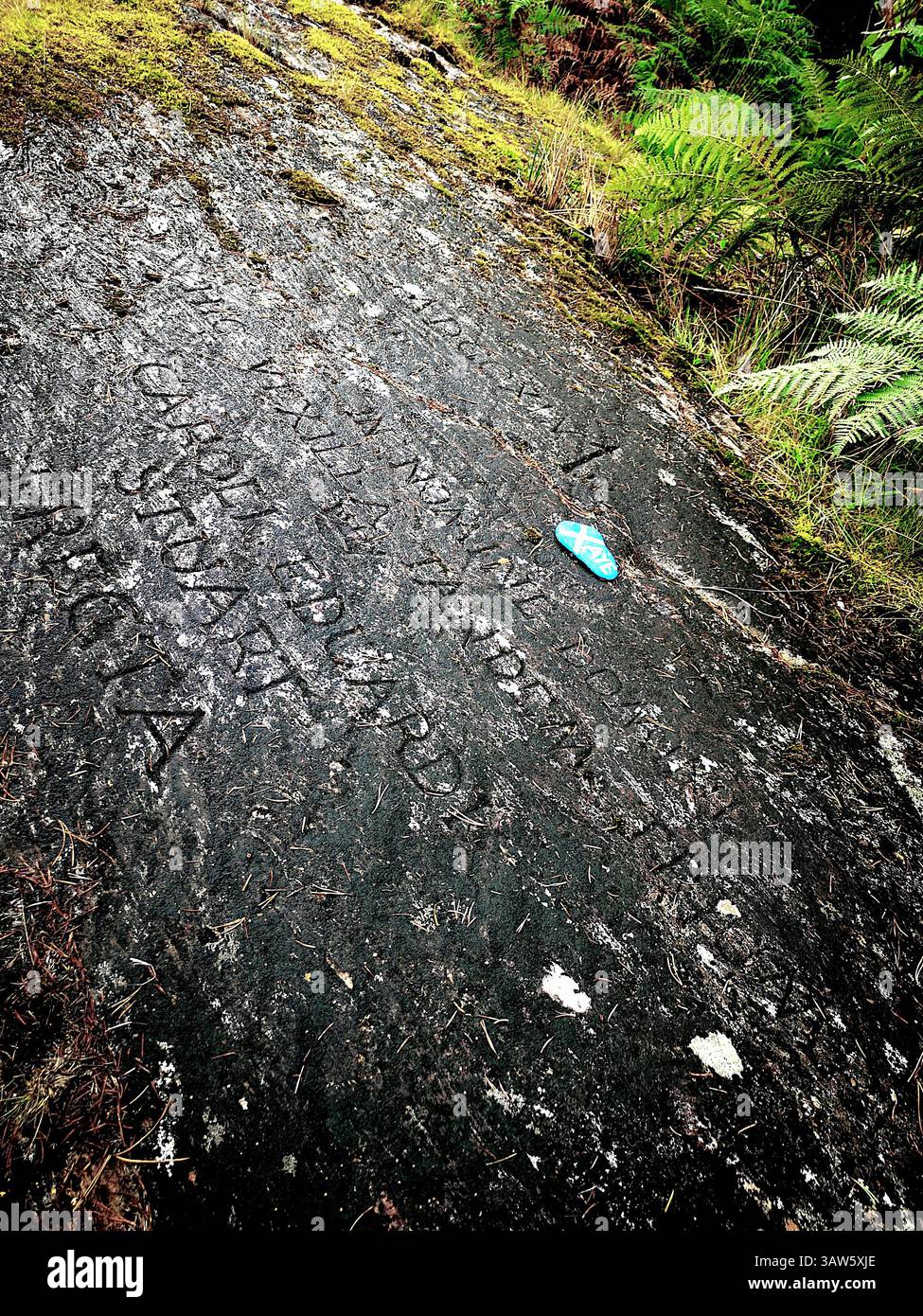 The real location where Bonnie Prince Charlie raised the Royal Standard during the 1745 rebellion in Glenfinnan. Latin engraved rock. - Smartphone Captured Stock Image