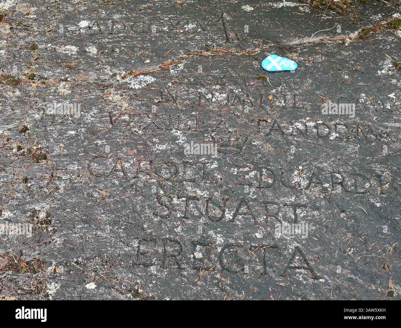The real location where Bonnie Prince Charlie raised the Royal Standard during the 1745 rebellion in Glenfinnan. Latin engraved rock. - Smartphone Captured Stock Image