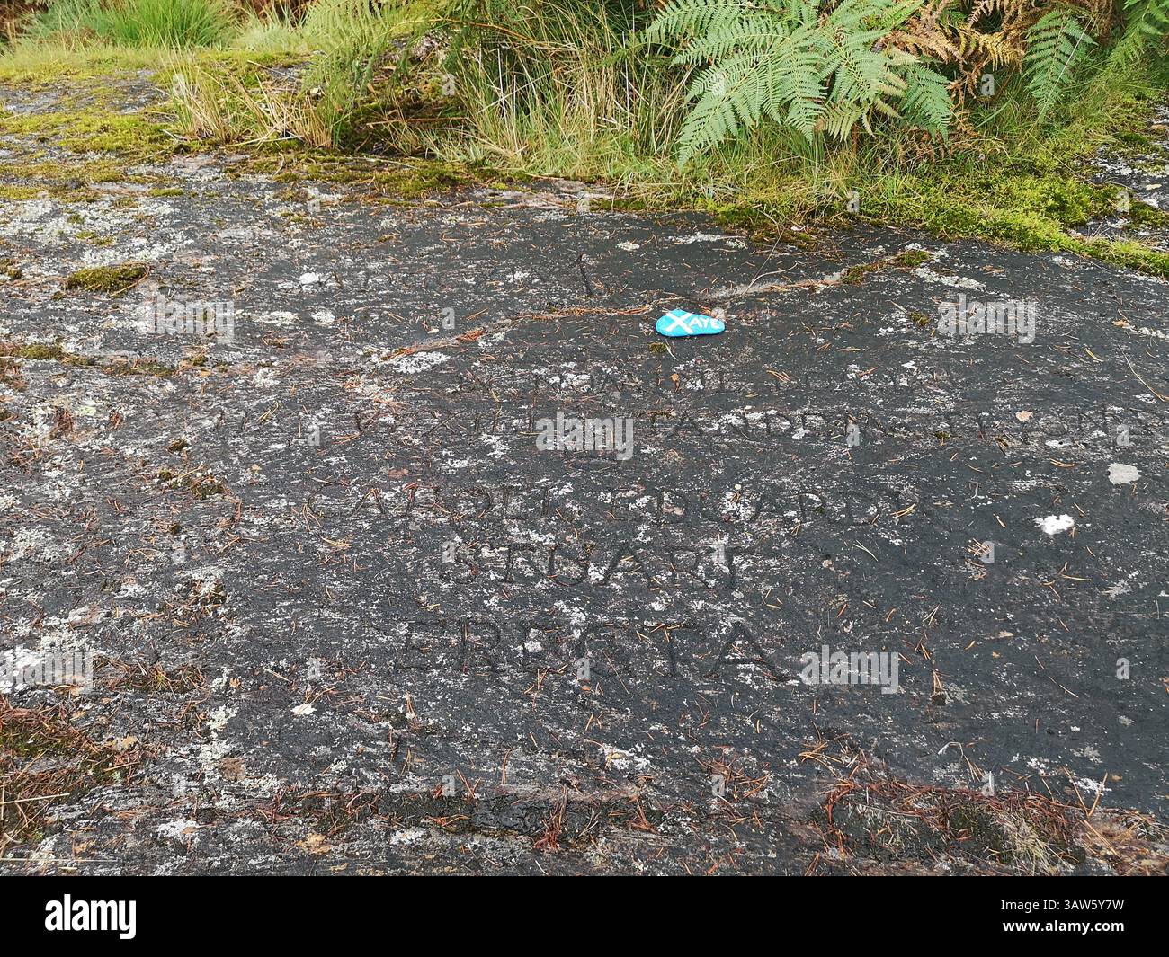 The real location where Bonnie Prince Charlie raised the Royal Standard during the 1745 rebellion in Glenfinnan. Latin engraved rock. - Smartphone Captured Stock Image