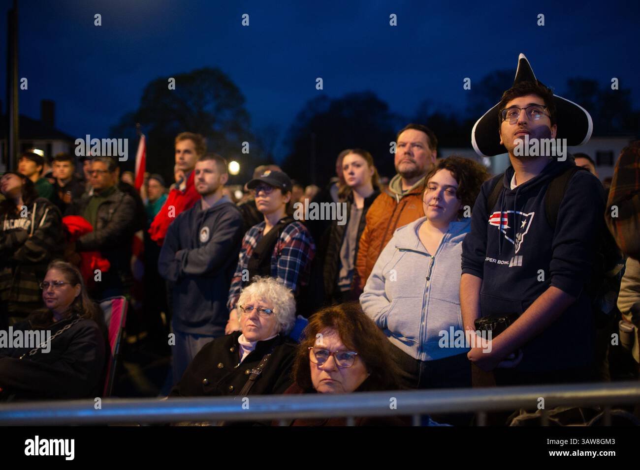 Lexington, USA. 19th Apr, 2025. Spectators watch a reenactment at the ...