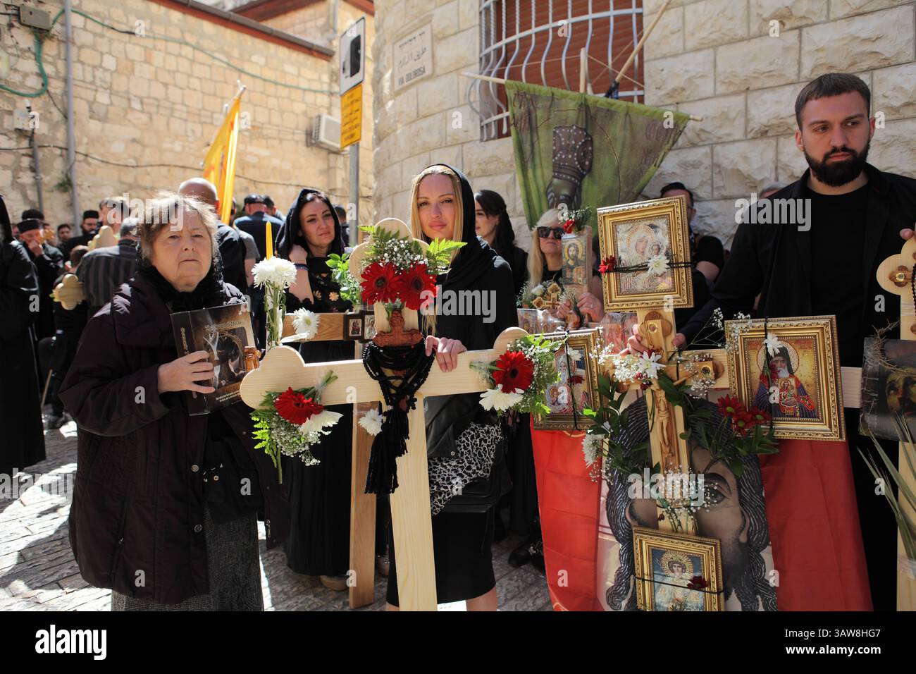 Serbian Orthodox pilgrims holding ornamented crosses & icons wait on ...