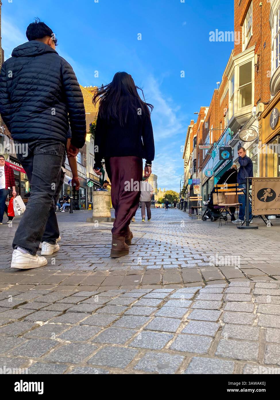Low angle shot of people hurrying about their business on Peascod Street in Windsor, Berkshire, UK - Smartphone Captured Stock Image
