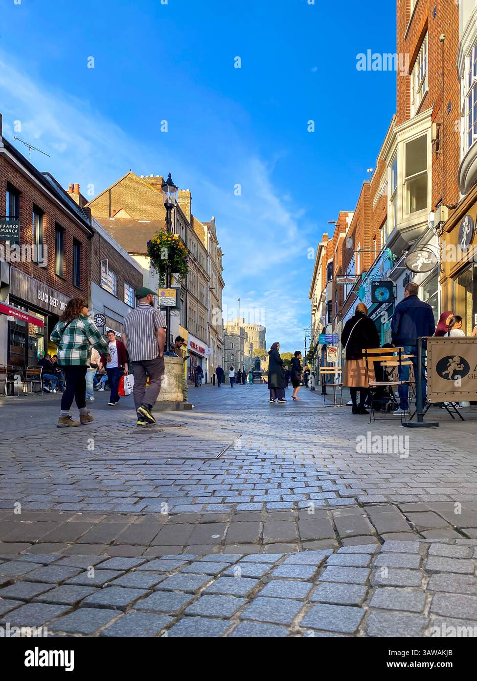 Low angle shot of people hurrying about their business on Peascod Street in Windsor, Berkshire, UK - Smartphone Captured Stock Image