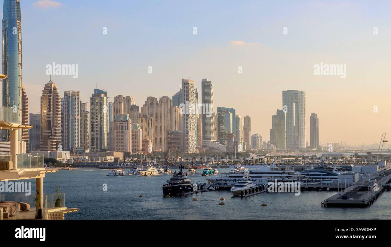 Stunning skyline of Dubai, with its impressive skyscrapers lining the coast alongside a bustling marina filled with luxurious yachts. Stock Photo