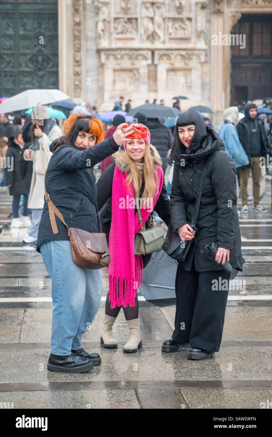 Group of three women outside Milan Cathedral taking a selfie. Piazza del Duomo, Milan, Italy. Stock Photo