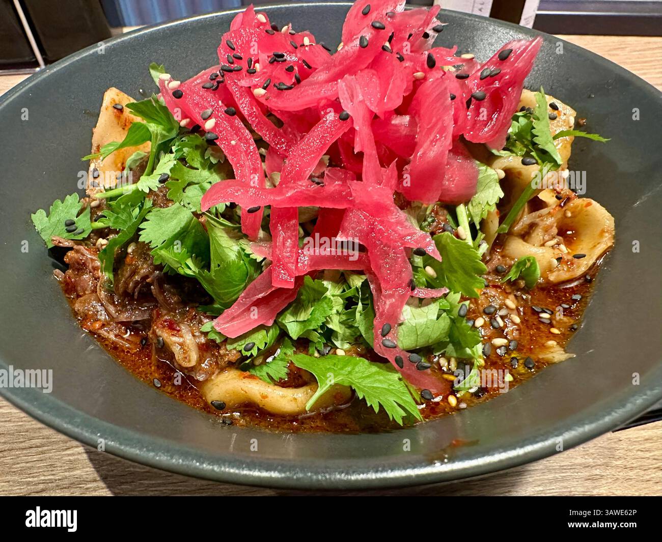 A bowl / plate of Chinese pulled noodles in chilli oil with beef - Smartphone Captured Stock Image