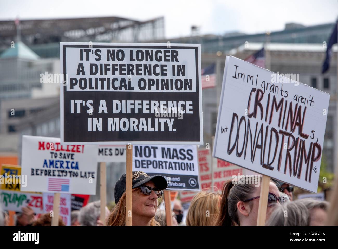 San Francisco, USA. 19th Apr 2025. Protesters crowd Civic Center Plaza to demonstrate at the “Stop the Billionaire Agenda” protest against the Trump Administration. Many protest signs are held high, some reading 'Mobilize to save America before it's too late,' 'It's no longer a difference in political opinion, it's a difference in morality,' 'and 'Immigrants aren't criminals, but Donald Trump is.' Credit: Shelly Rivoli/Alamy Live News - Stock Image