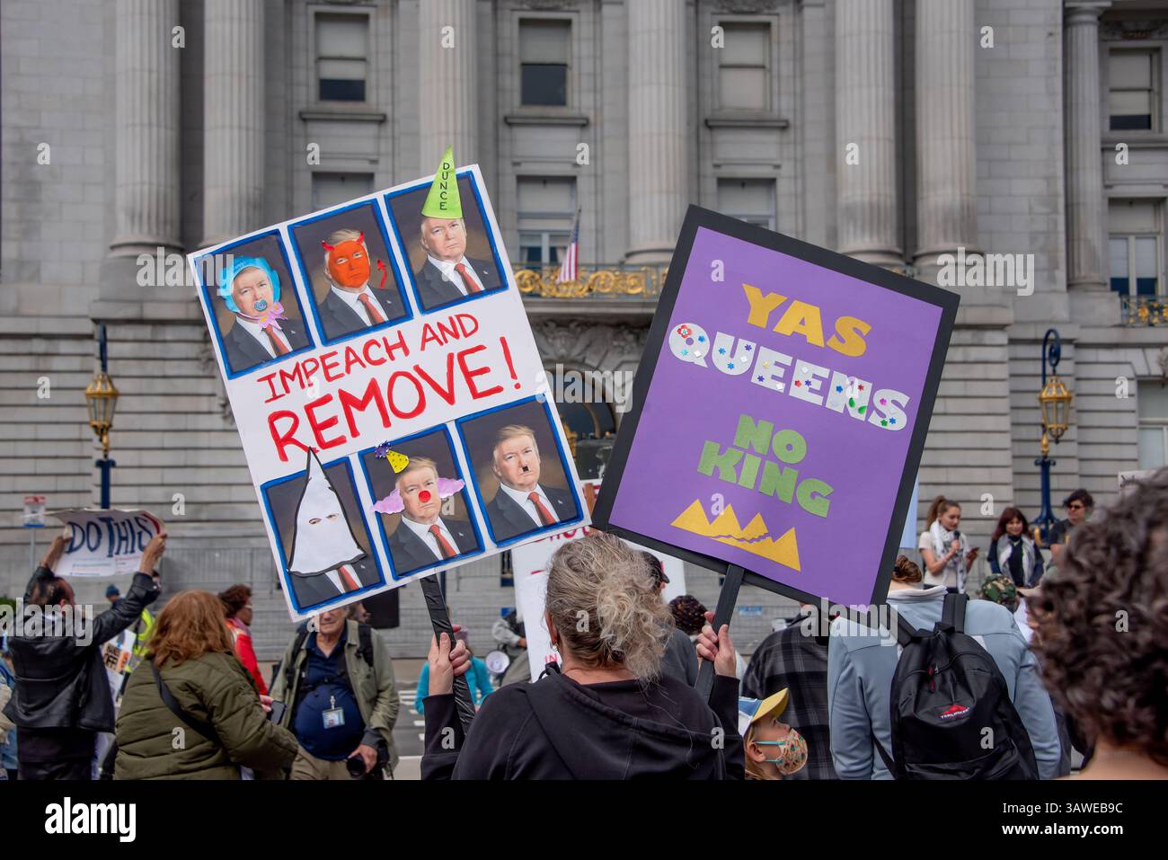 San Francisco, USA. 19th Apr 2025. Protesters gather in front of San Francisco City Hall,  one holding two  signs reading 'Impeach and Remove!' and 'Yas Queens. No King.' The “Stop the Billionaire Agenda” protest against the Trump Administration is one of many anti-trump demonstrations held in the city today. Credit: Shelly Rivoli/Alamy Live News - Stock Image
