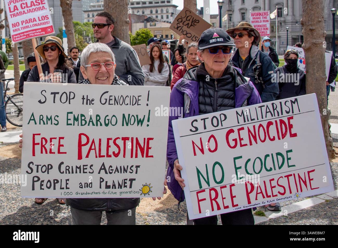San Francisco, USA. 19th Apr 2025. At the Civic Center Plaza “Stop the Billionaire Agenda” protest against the Trump Administration, two older women hold signs demanding, 'Stop the Genocide! Arms embargo  now! Free Palestine, ' and 'Stop Militarism. no Genocide, No Ecocide, Free Palestine,' and noted '1000 Grandmothers for Future Generations.'  Credit: Shelly Rivoli/Alamy Live News - Stock Image