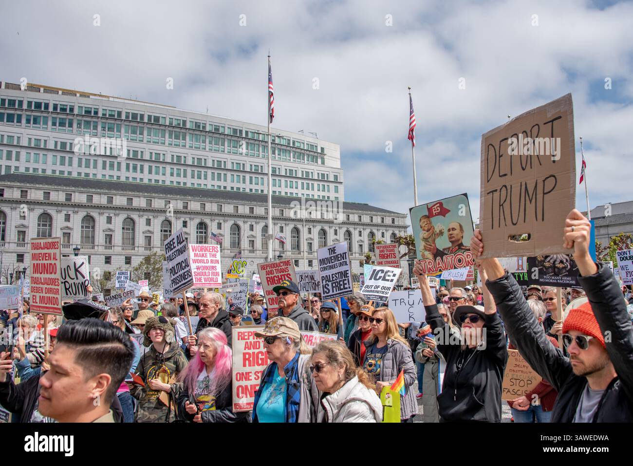 San Francisco, USA. 19th Apr 2025. A large crowd of protesters gathers at Civic Center Plaza for the “Stop the Billionaire Agenda” protest against the Trump Administration. Numerous protest signs are seen among the people addressing concerns about Palestine, reproductive and trans rights, ICe and immigration, and more. Credit: Shelly Rivoli/Alamy Live News - Stock Image