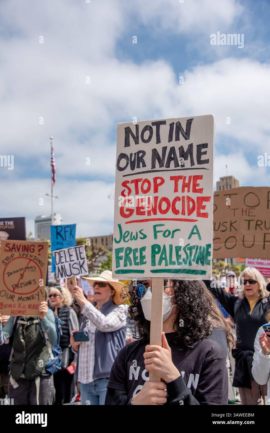 San Francisco, USA. 19th Apr 2025. At the Civic Center Plaza “Stop the Billionaire Agenda” protest against the Trump Administration, a protester  holds a sign reading, 'Not in our Name. Stop the Genocide. Jews for a Free Palestine.' Credit: Shelly Rivoli/Alamy Live News - Stock Image