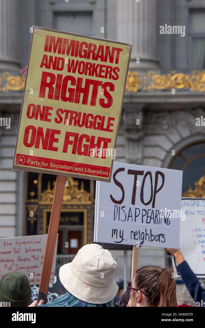 San Francisco, USA. 19th Apr 2025. Protesters gather at Civic Center Plaza for the “Stop the Billionaire Agenda” protest against the Trump Administration. Two protesters hold signs addressing immigration and deportation read, 'Immigrant and workers rights, One sturggle, One fight,' and 'Stop disappearing my neighbors.' Credit: Shelly Rivoli/Alamy Live News - Stock Image