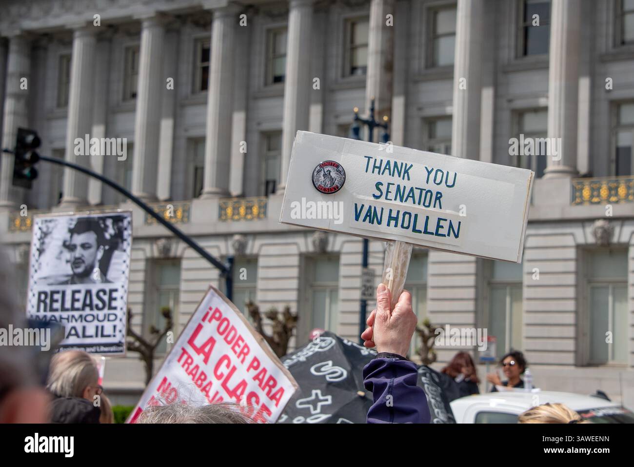 San Francisco, USA. 19th Apr 2025. Above the crowd at the Civic Center Plaza “Stop the Billionaire Agenda” protest against the Trump Administration, one sign reads, 'Thank you Senator Van Hollen,' in reference to the Senator from Maryland who traveled to El Salvador this week to meet with the wrongly deported Kilmar Abrego Garcia. Credit: Shelly Rivoli/Alamy Live News - Stock Image