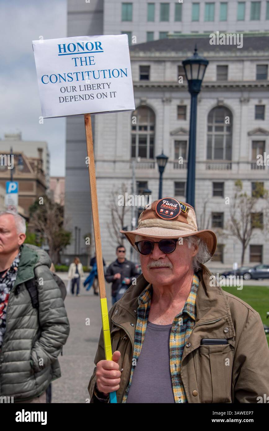 San Francisco, USA. 19th Apr 2025. At the Civic Center Plaza “Stop the Billionaire Agenda” protest against the Trump Administration, a man holds a sign reading, 'Honor the Constitution, our liberty depends on it.' Credit: Shelly Rivoli/Alamy Live News - Stock Image