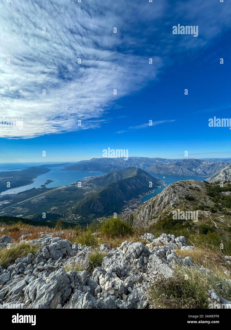 Stunning vista of Kotor and its bay as seen from Mount Lovćen, surrounded by dramatic mountains. - Smartphone Captured Stock Image