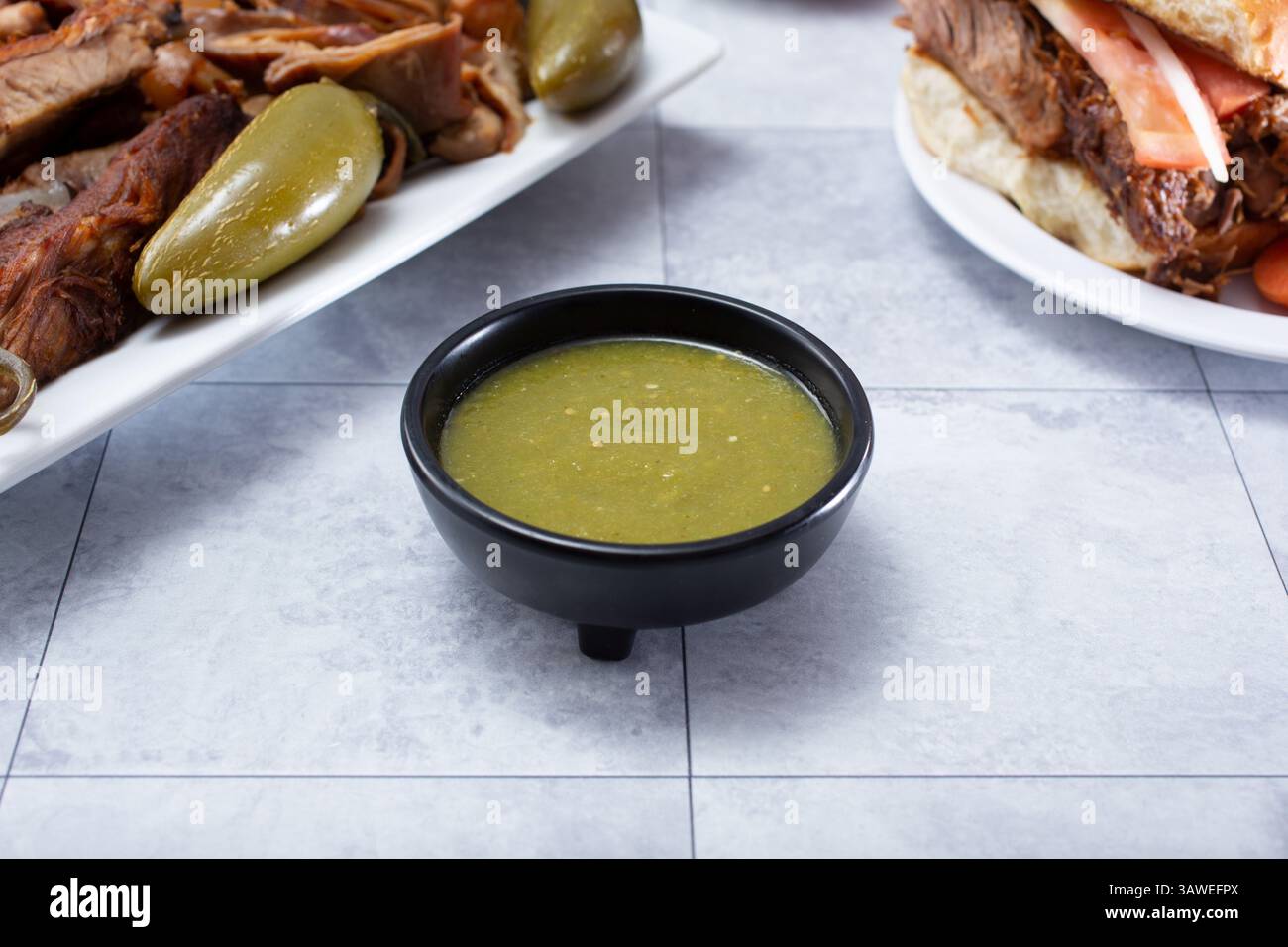 A view of a condiment cup filled with salsa verde. Stock Photo