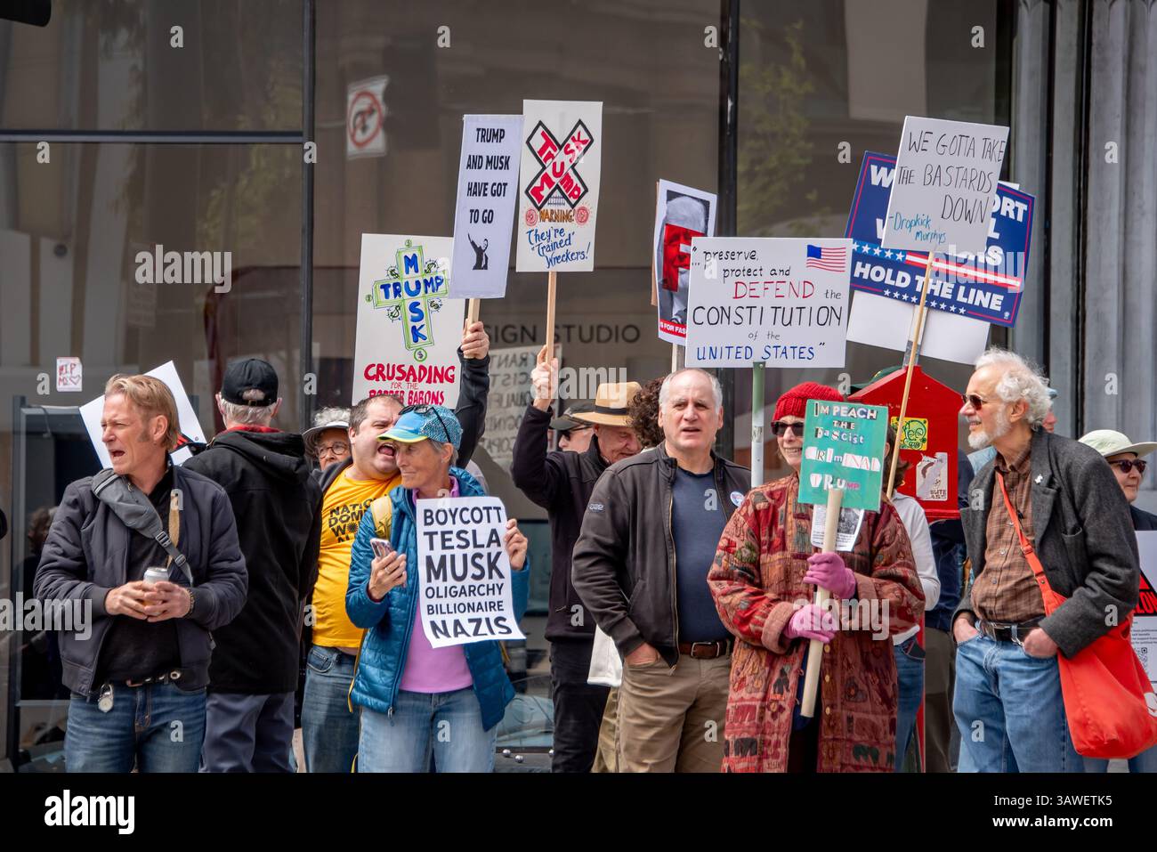 San Francisco, USA. 19th Apr 2025. Protesters gather outside the Tesla showroom and dealership in San Francisco with assorted signs reading, 'Boycott Tesla, Musk, oligarchy, billionaire nazis,' 'Trump and Musk have got to go,' 'Preserve, protect and defend the Constitution of the United States,' and 'We gotta take the bastards down.' Credit: Shelly Rivoli/Alamy Live News - Stock Image