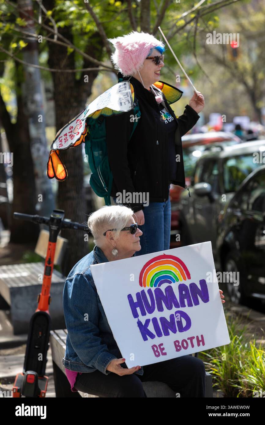 Seattle, Washington, USA. 19th April 2025. Bystanders along Broadway Ave watch the 'We the People Means Everyone' rally and march pass in Seattle on Saturday, April 19, 2025. The demonstration in support of democracy, diversity and equity is part of a national day of action against actions of the Trump administration. Credit: Paul Christian Gordon/Alamy Live News Stock Photo