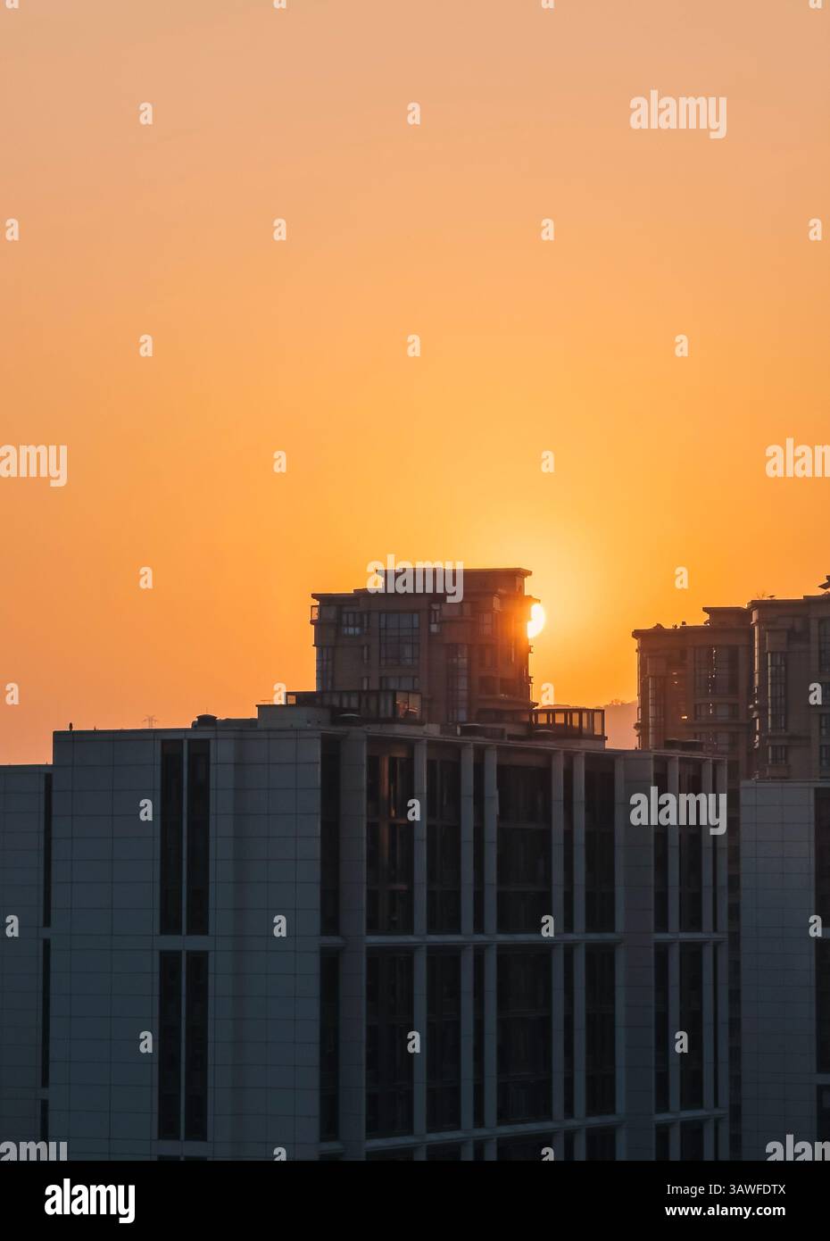 Golden sunrise illuminating modern buildings in an urban landscape Stock Photo
