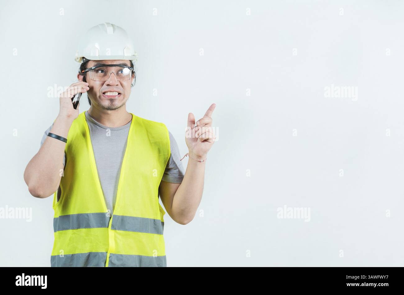 Handsome engineer calling on phone isolated. Constructor engineer talking phone isolated Stock Photo