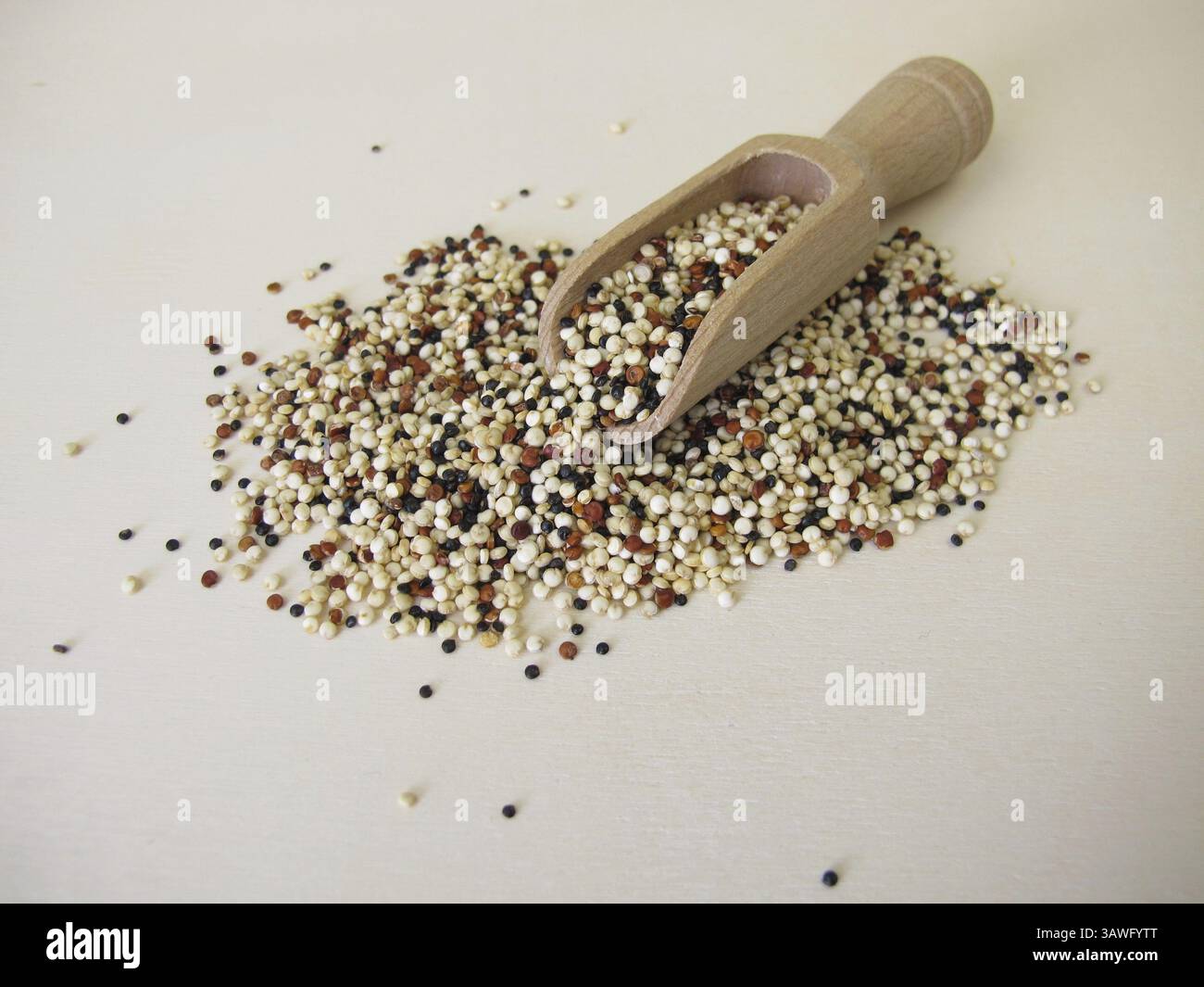 White, black and red quinoa on a wooden board Stock Photo