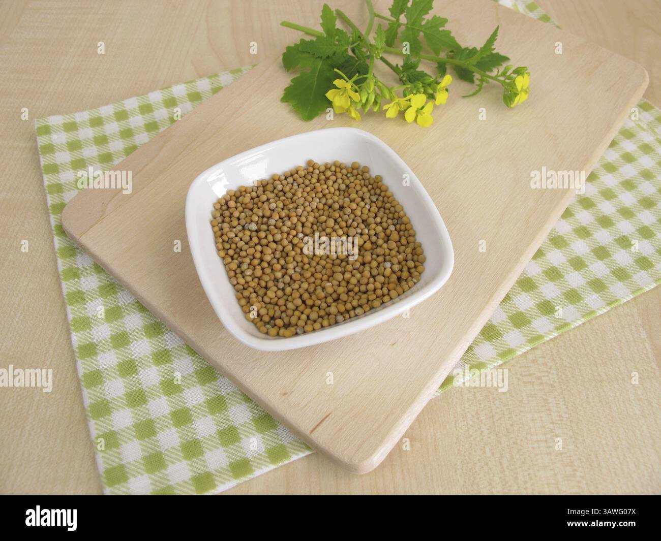Mustard herb with flowers and mustard seeds Stock Photo