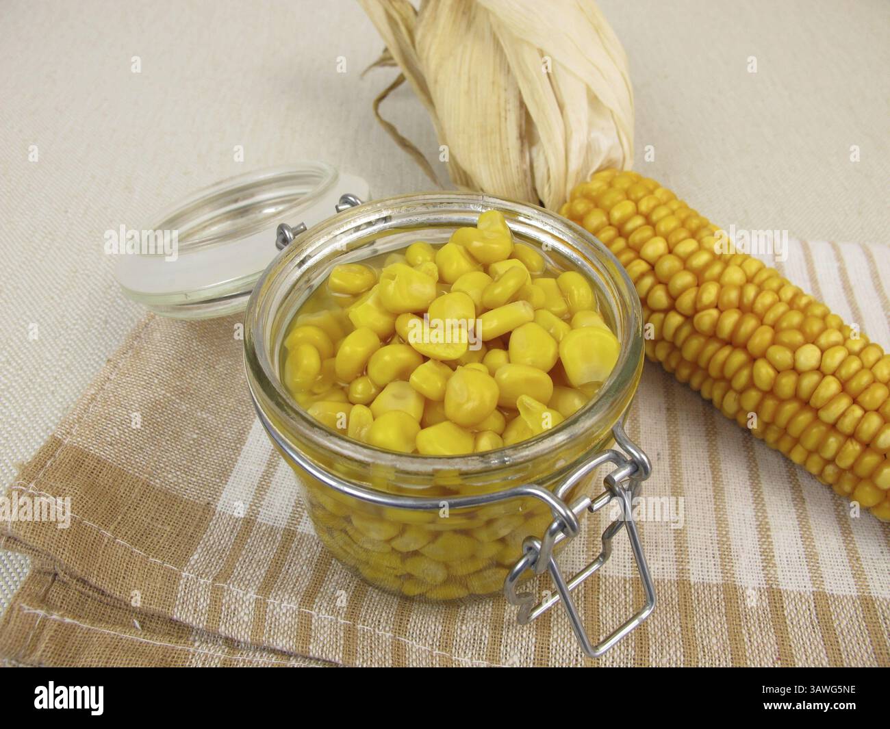 Cooked corn kernels in a jar Stock Photo - Alamy