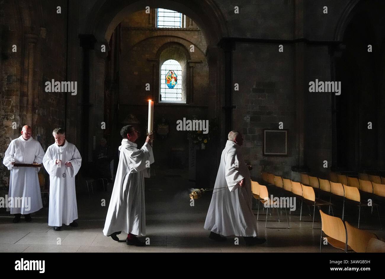 The Dean of Chichester Cathedral, The Very Reverend Dr Edward Dowler (2nd right) carries the Paschal Candle into Chichester Cathedral after it was lit in a ceremony ahead of the Easter Vigil. Picture date: Saturday April 19, 2025. Stock Photo