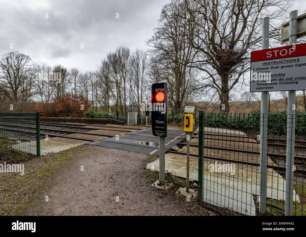 Pedestrian railway level crossing controlled by lights in rural environment in Northumberland, England, UK Stock Photo