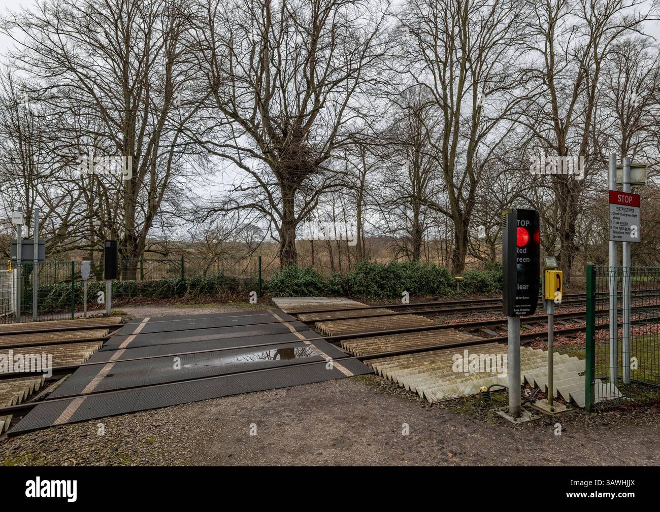 Pedestrian railway level crossing controlled by lights in rural environment in Northumberland, England, UK Stock Photo