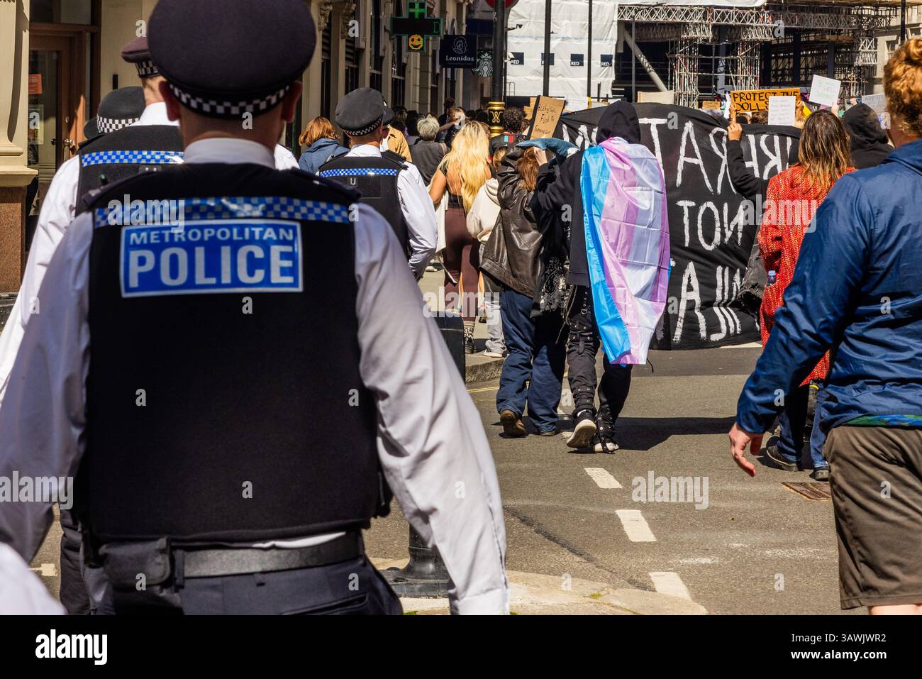 London, UK. 19 APR, 2025. Police follow masked activists as thousands ...