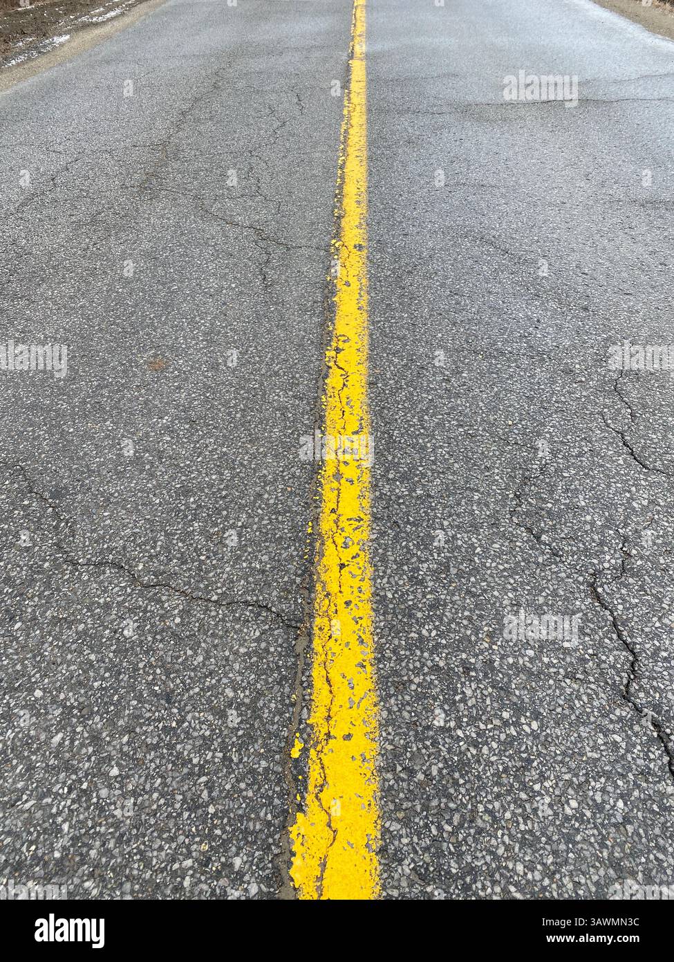 Yellow line painted on asphalt road - Smartphone Captured Stock Image