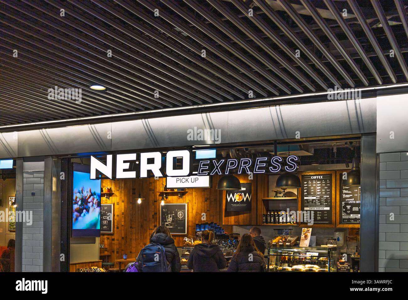 Nero Express Coffee Shop Entrance with Illuminated Sign. London, UK, 11 February 2024 Stock Photo