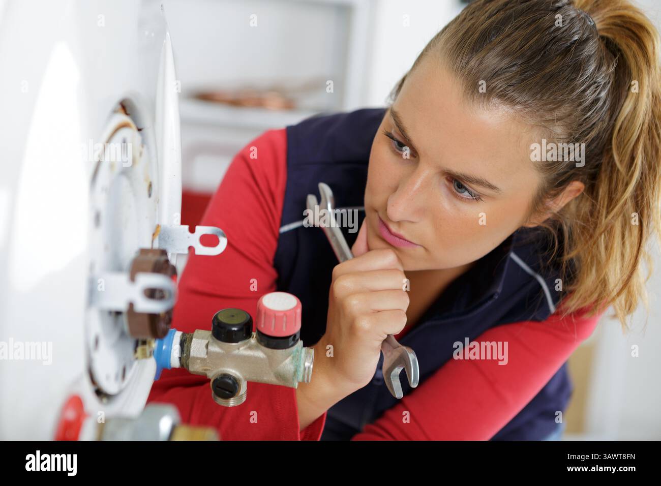 female factory worker using wrench tool repairing a machine Stock Photo ...