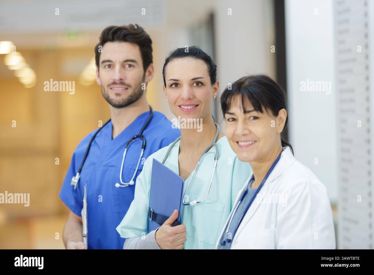 team of doctors standing in hospital corridor Stock Photo - Alamy