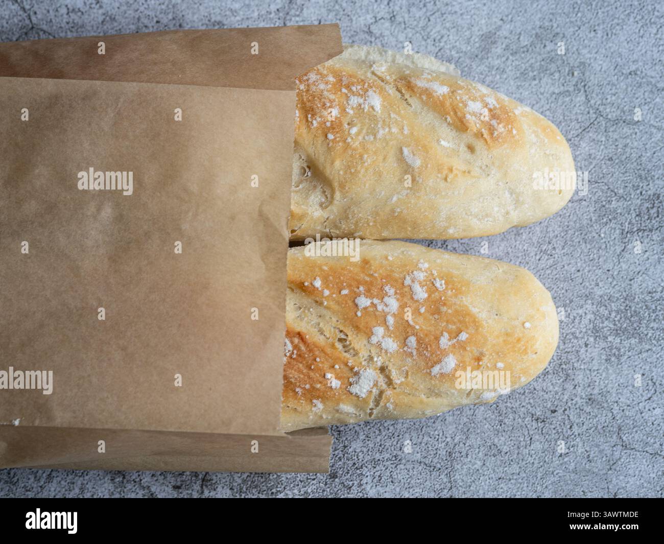 two crusty bread baguettes in a paper bag Stock Photo - Alamy