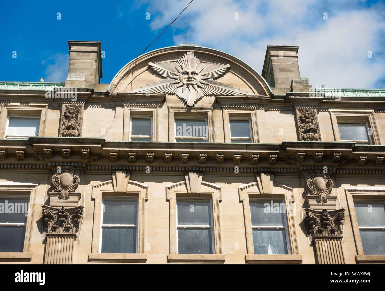 Architectural detail on the Sun Insurance Building showing carved sun emblem, in Newcastle upon Tyne, England, UK Stock Photo