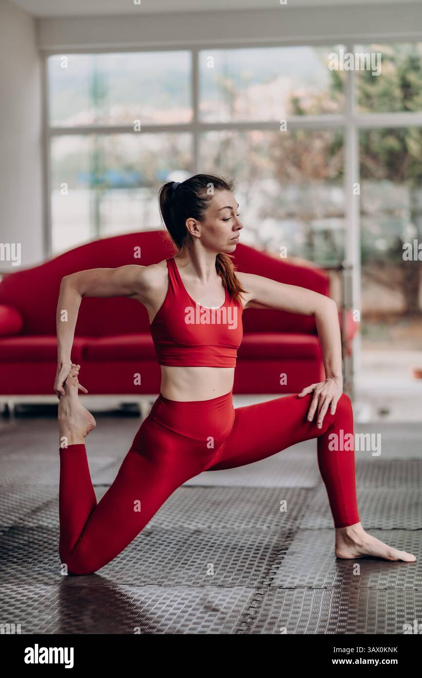 Poised control in dynamic quad stretch with focused still energy Stock Photo