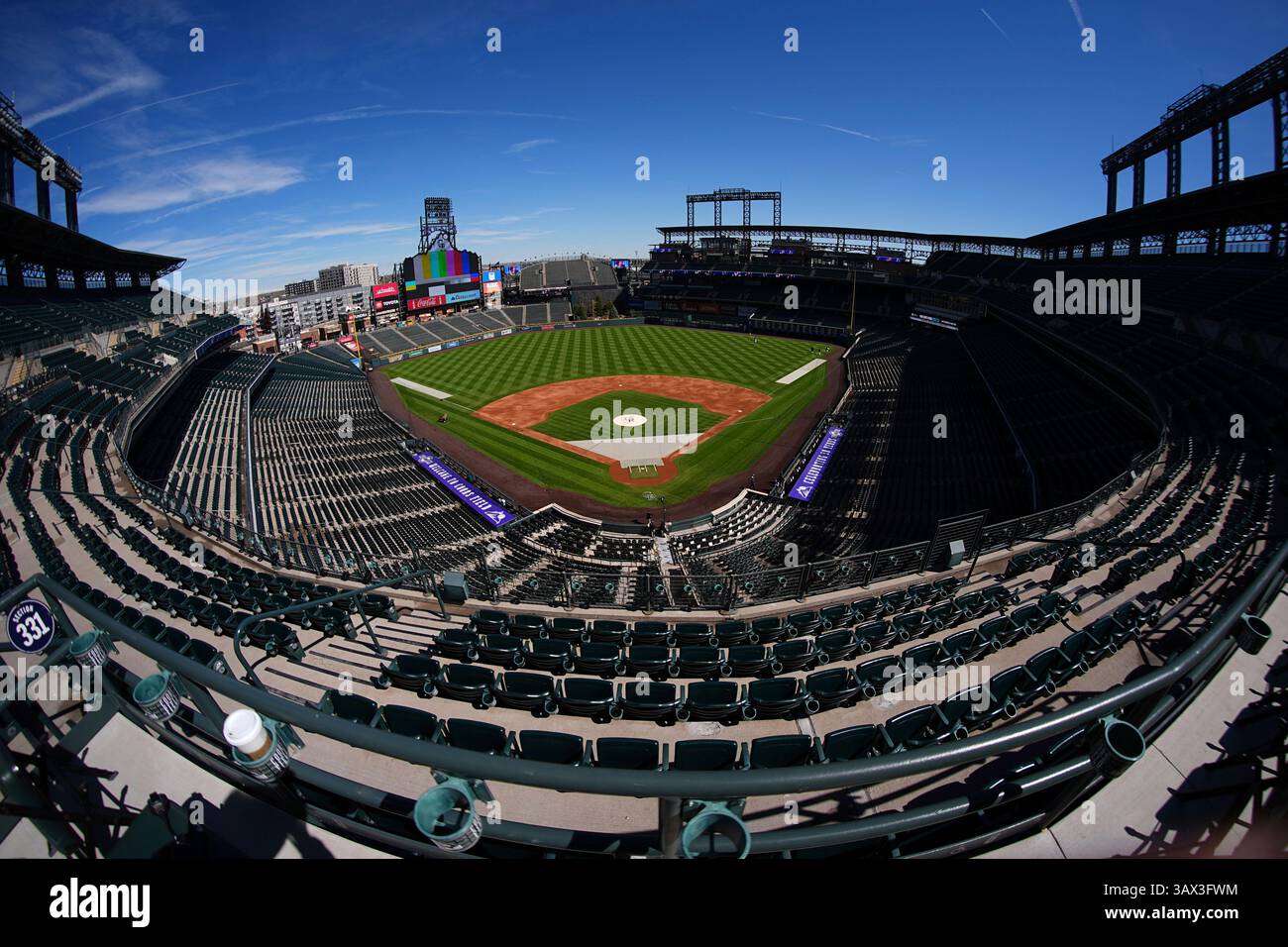 Toil Split As viewed through a fisheye lens, workers toil to prepare Coors Field ...