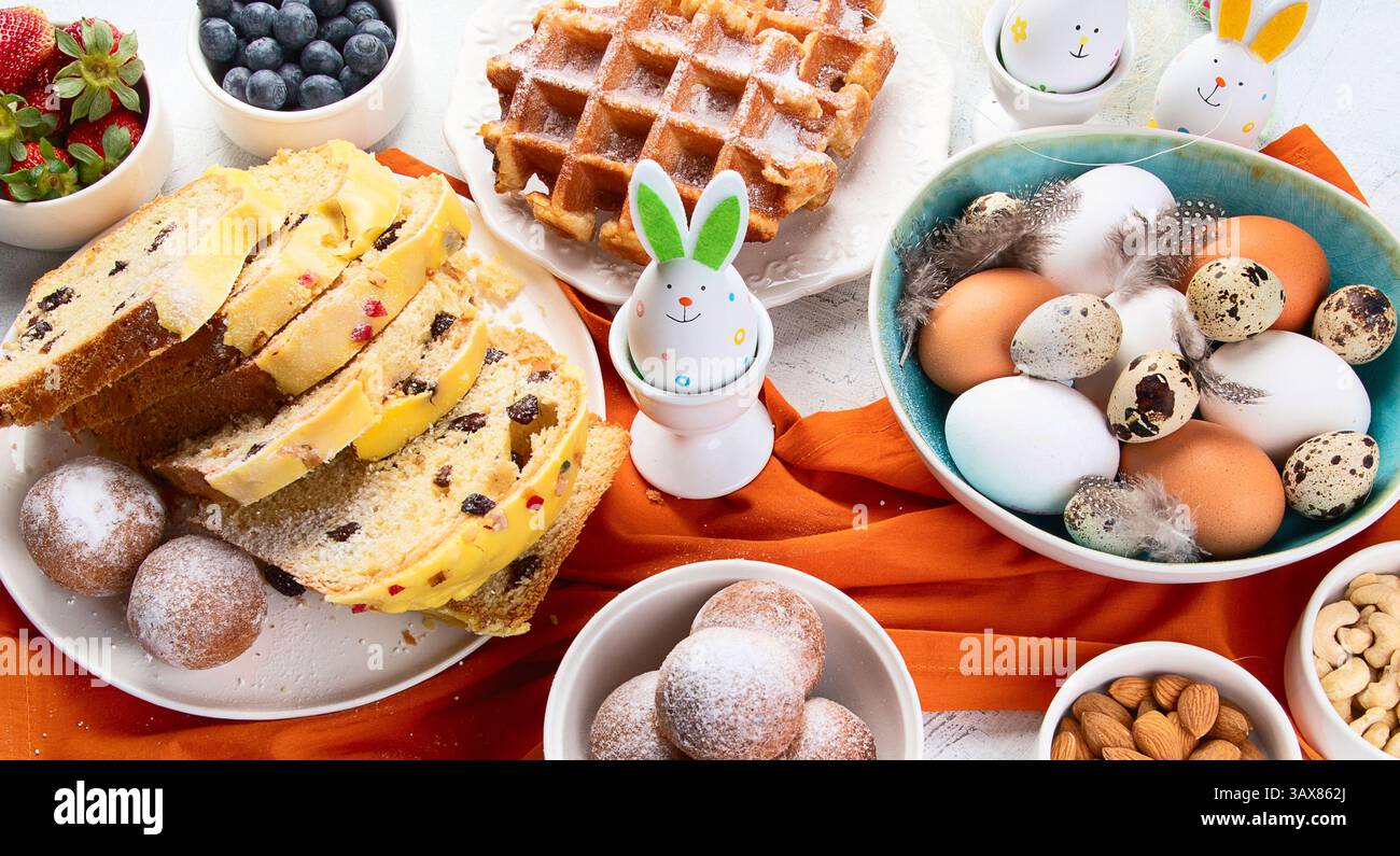 Festive Easter table setting. Happy Easter. Stylish Easter eggs in plate. Top view. Stock Photo