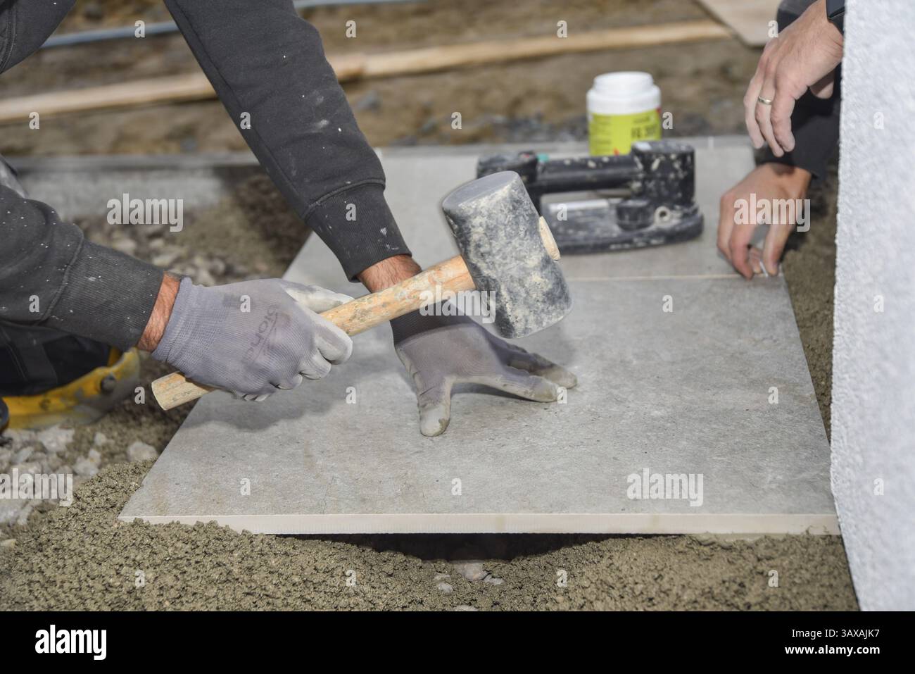Craft tiler on a construction site - construction workers and construction industry Stock Photo