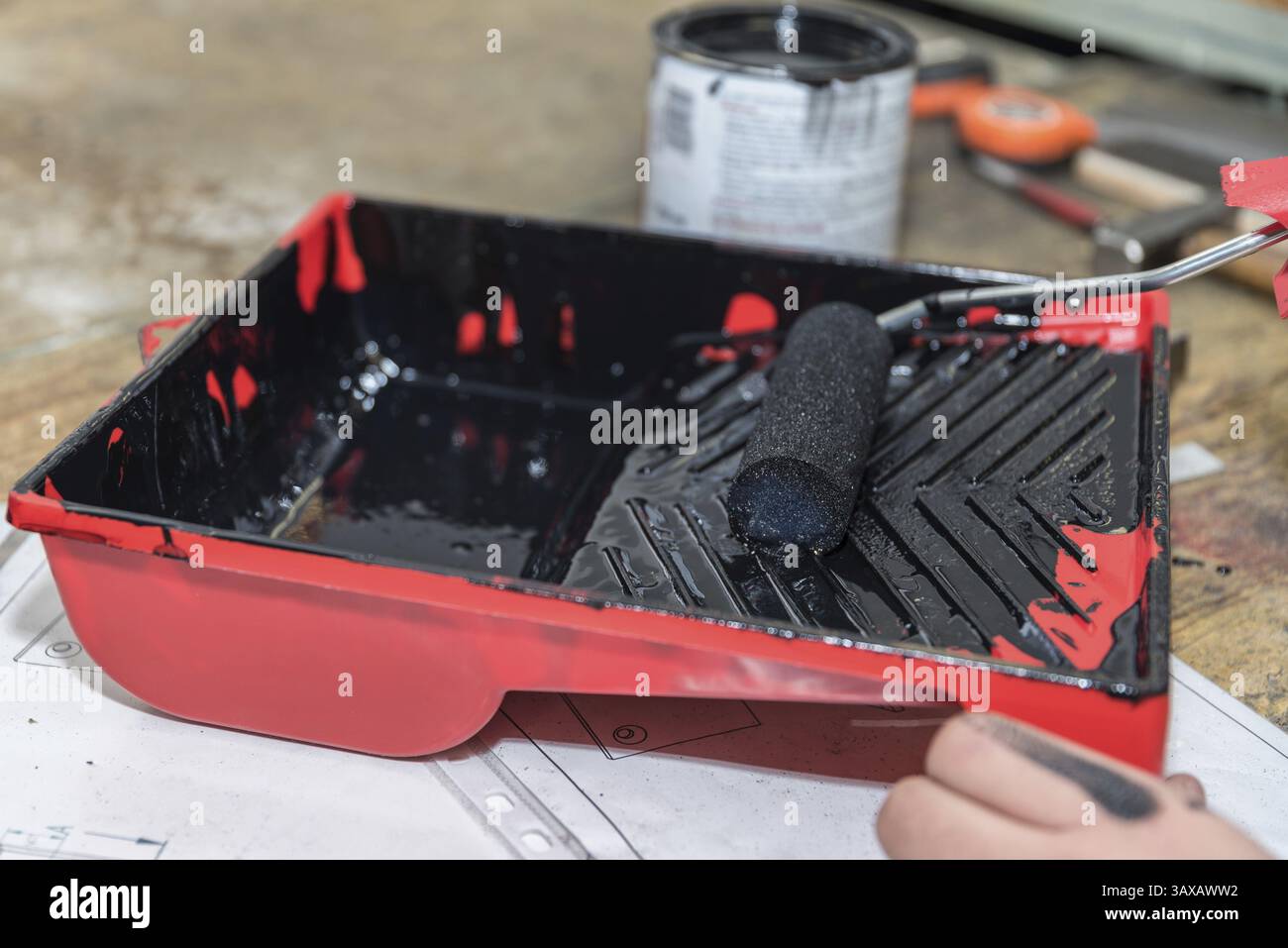 A foam roller is stripped in an ink tray Stock Photo