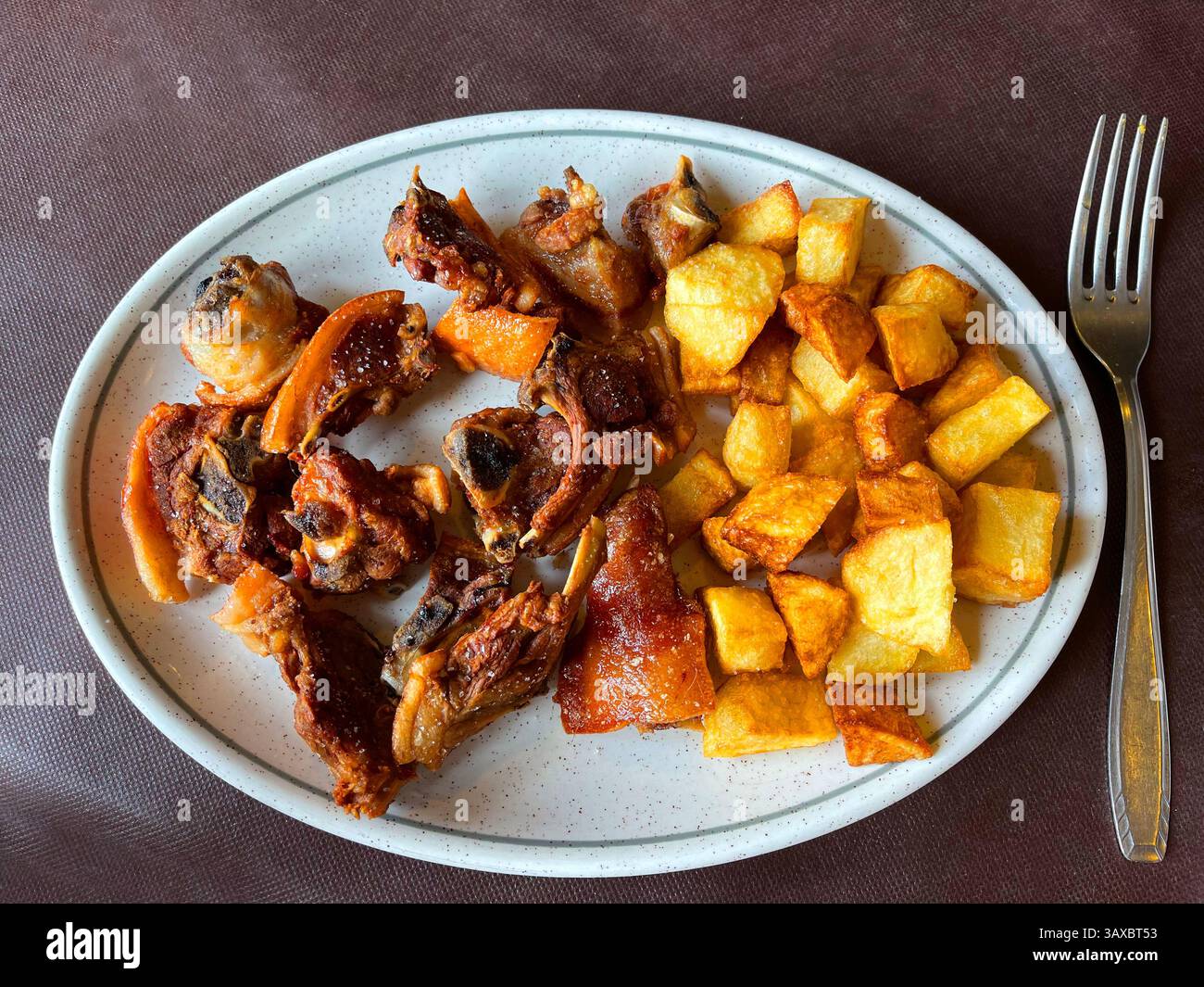 Cochifrito, fried pork meat with potatoes. Spain. - Smartphone Captured Stock Image