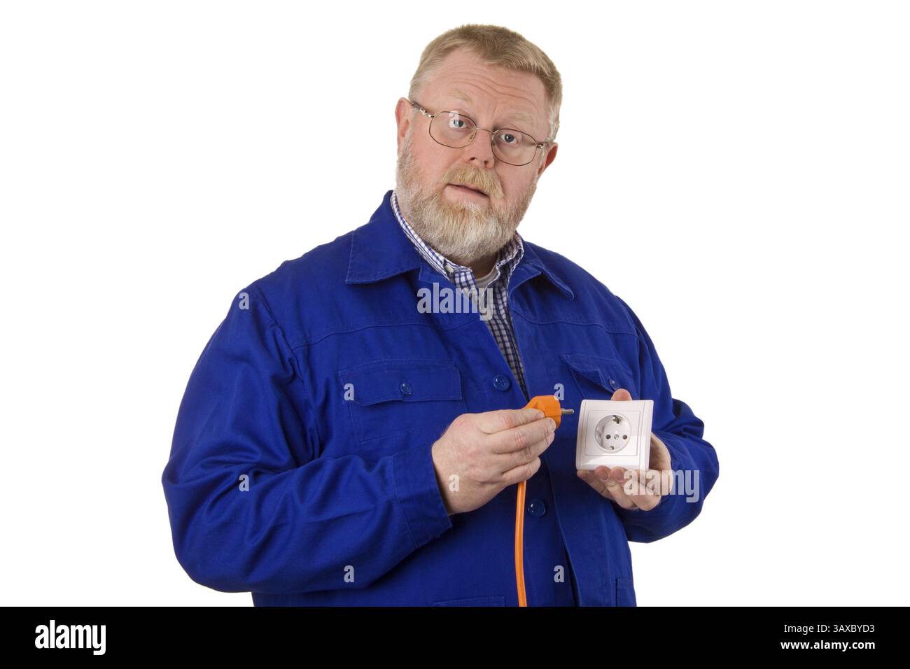Electrician inserts orange plug into a socket - optional Stock Photo